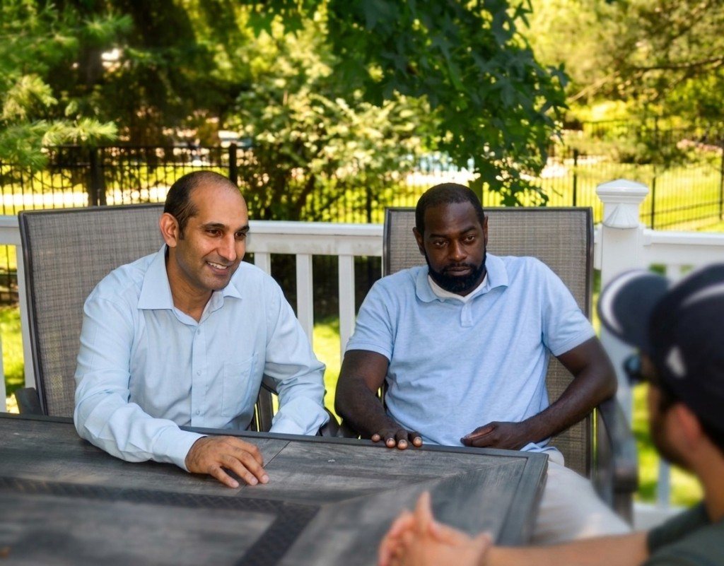 Inderpreet Banga and Eugene Tawiah talking with a concerned parent